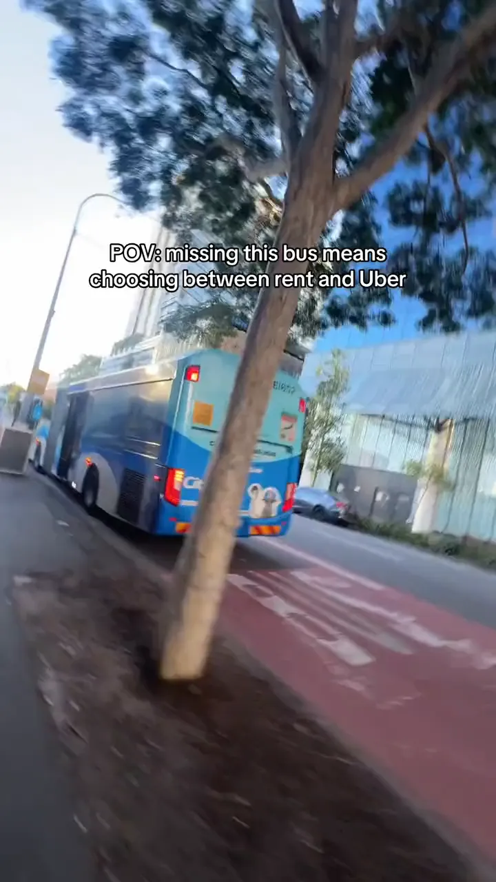 Phone-held shot of a Brisbane bus pulling in, then MJ stepping on board.