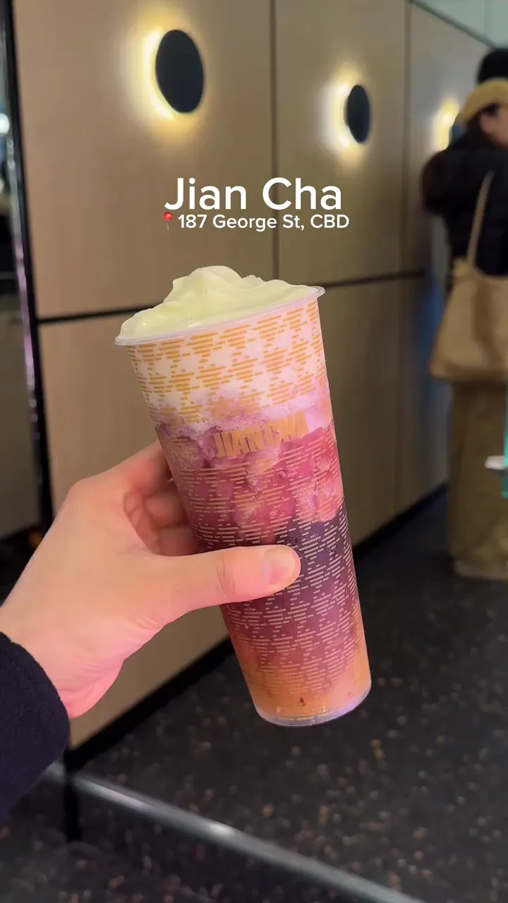 A Jian Cha Grape Tea Slushie with cream cheese held up inside the George St store, then MJ tastes the cream cheese.