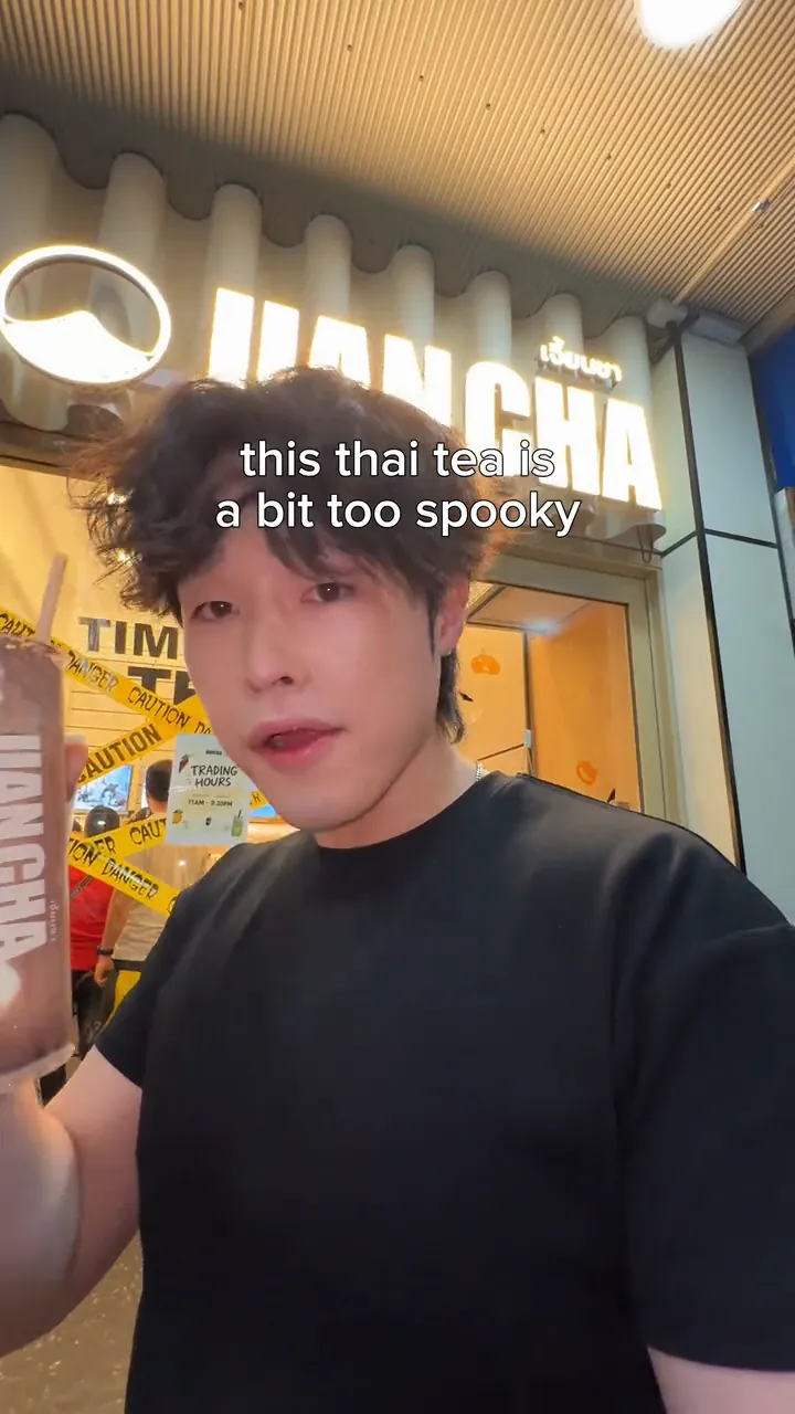 MJ in front of the Jian Cha shopfront on George St, holding the Halloween cup